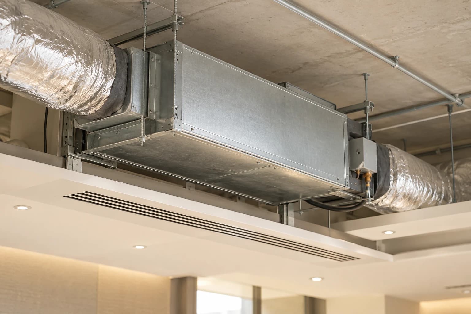 Concealed ducted air-conditioning unit above a ceiling with a linear diffuser